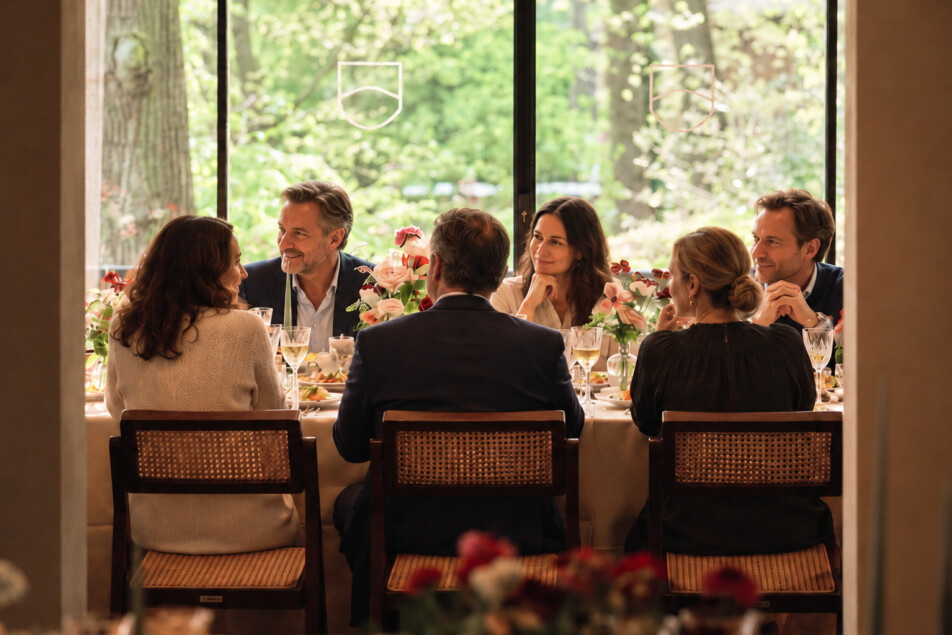 Six diners by a forest window